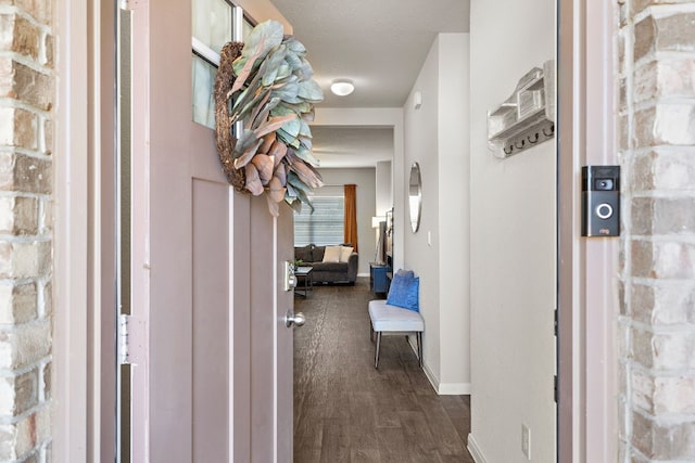 hallway with dark hardwood / wood-style flooring and a textured ceiling