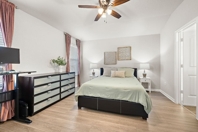 bedroom with light hardwood / wood-style flooring, ceiling fan, and lofted ceiling