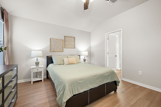 bedroom with hardwood / wood-style flooring, vaulted ceiling, and ceiling fan