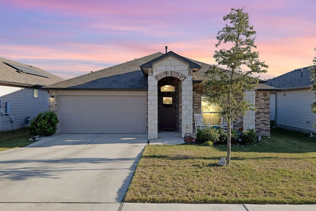 view of front of house with a lawn and a garage