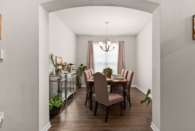 dining room featuring a notable chandelier and dark hardwood / wood-style flooring