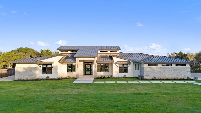 1007 County Road 290, Leander, TX 78641 - rear view of property featuring a standing seam roof, metal roof, a lawn, stone siding, and stucco siding
