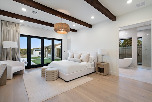 bedroom featuring multiple windows, light wood-type flooring, and french doors