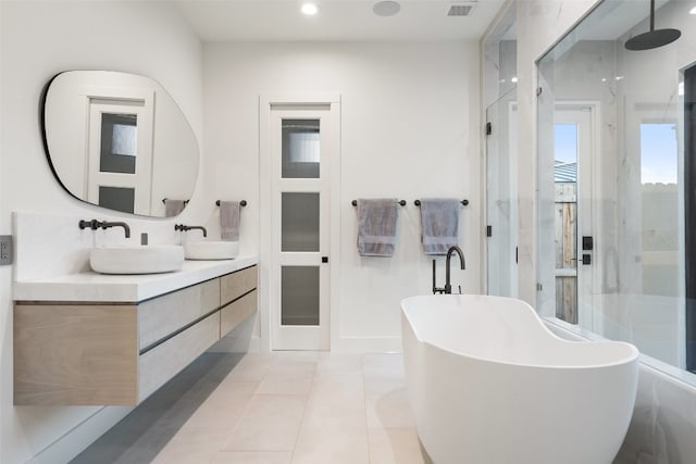 bathroom with vanity, shower with separate bathtub, and tile patterned floors