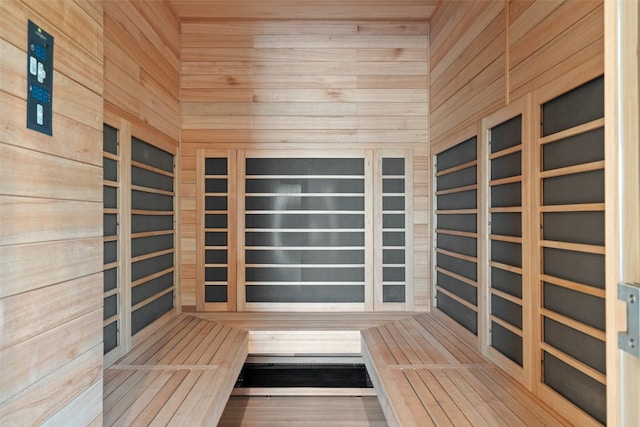 view of sauna with wood walls and hardwood / wood-style flooring