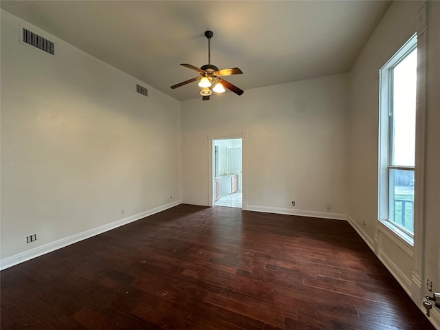 empty room featuring ceiling fan and dark wood-type flooring