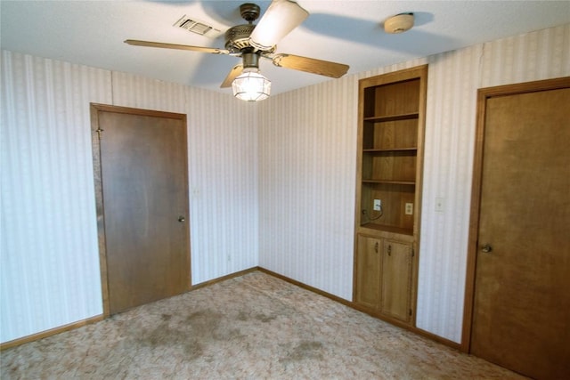 209 Simpson St, Schulenburg, TX 78956 - spare room with wallpapered walls, a smoke detector, carpet flooring, and a ceiling fan