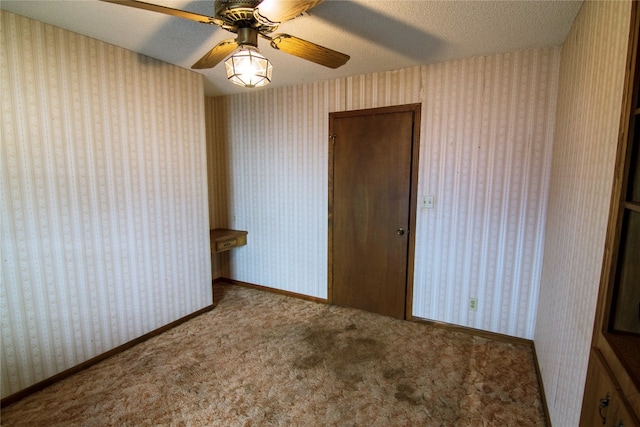 unfurnished bedroom featuring a textured ceiling, ceiling fan, light colored carpet, and a closet