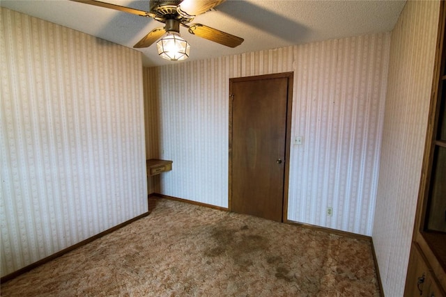 209 Simpson St, Schulenburg, TX 78956 - empty room featuring wallpapered walls, a textured ceiling, carpet floors, and ceiling fan