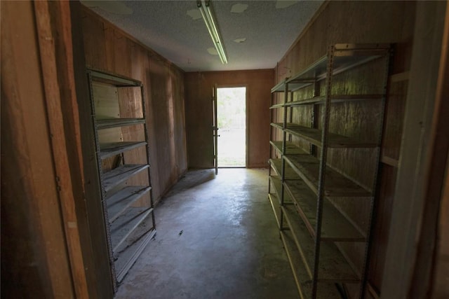 209 Simpson St, Schulenburg, TX 78956 - corridor featuring concrete floors and wooden walls