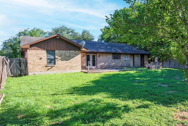 back of house with a lawn