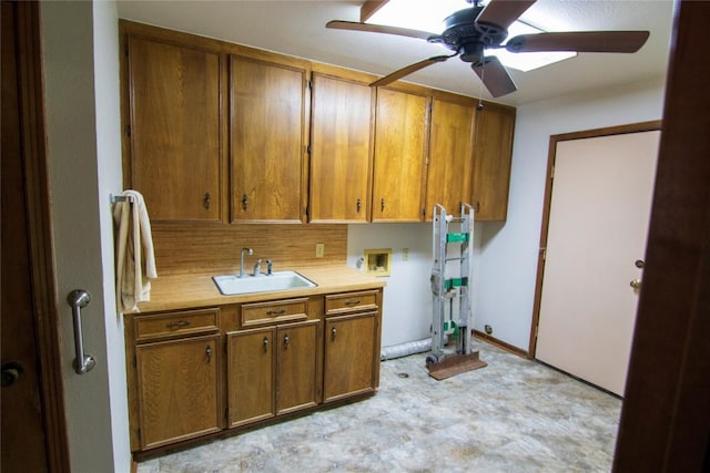 209 Simpson St, Schulenburg, TX 78956 - kitchen featuring light countertops, brown cabinetry, a sink, ceiling fan, and tasteful backsplash