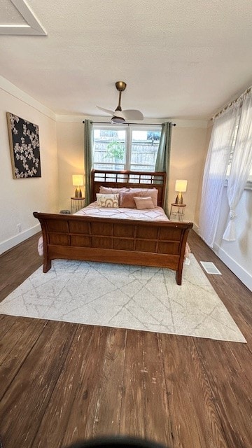 bedroom with ceiling fan, a textured ceiling, and hardwood / wood-style flooring