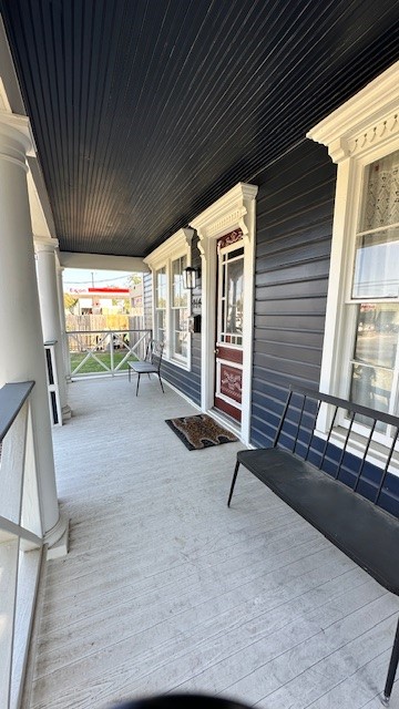 wooden terrace featuring covered porch