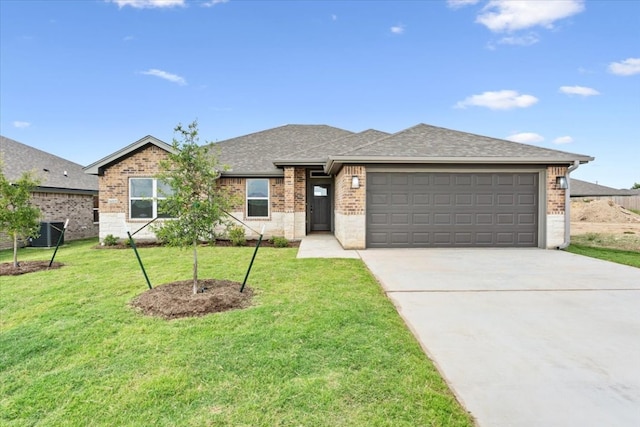 single story home with a front yard, a garage, and central AC unit