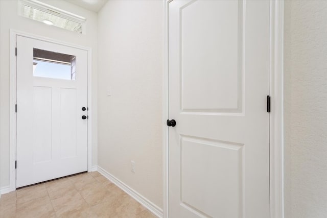 foyer entrance featuring light tile patterned flooring