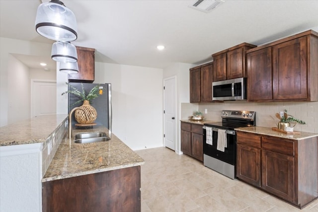 kitchen with sink, a kitchen island, dark brown cabinets, backsplash, and stainless steel appliances