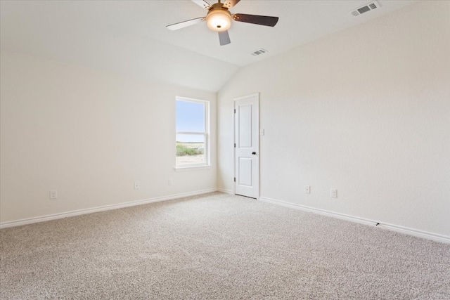 empty room featuring vaulted ceiling, ceiling fan, and light colored carpet