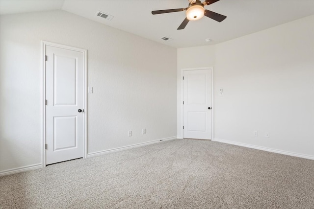 spare room with carpet floors, vaulted ceiling, and ceiling fan