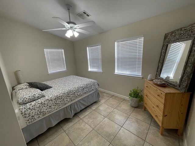 tiled bedroom with ceiling fan