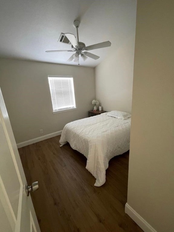 bedroom with ceiling fan and dark hardwood / wood-style floors