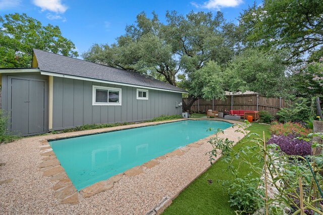 view of swimming pool with a storage unit