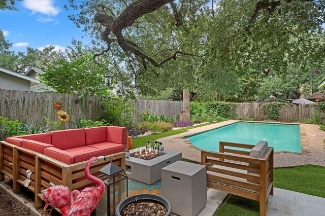 view of swimming pool featuring an outdoor living space with a fire pit and a patio area