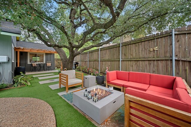 view of patio / terrace with an outdoor living space with a fire pit