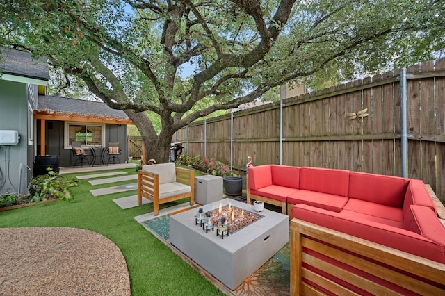 view of patio / terrace with fence private yard and an outdoor living space with a fire pit