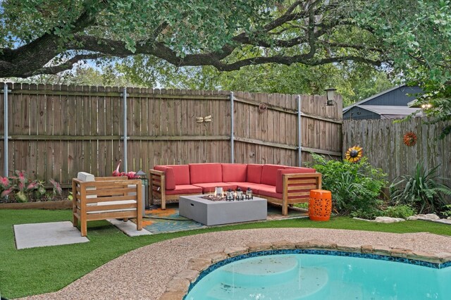 view of swimming pool with an outdoor living space with a fire pit and a patio area