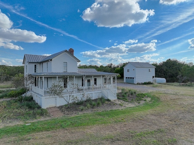 exterior space with a porch and a garage