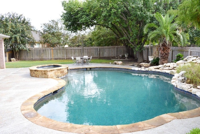 view of pool with a patio area and an in ground hot tub