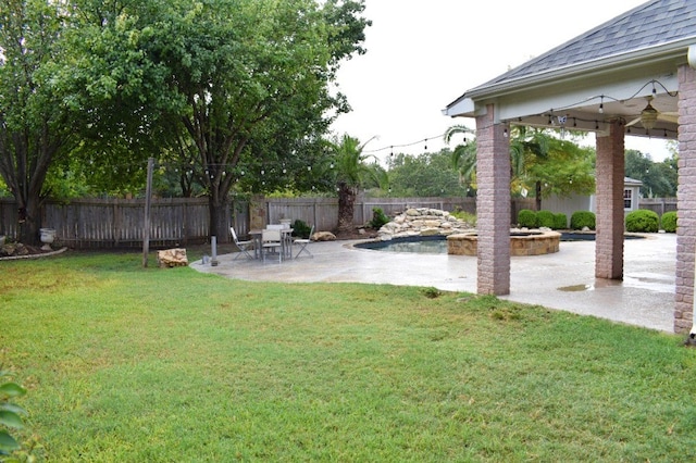 view of yard with a fenced in pool and a patio