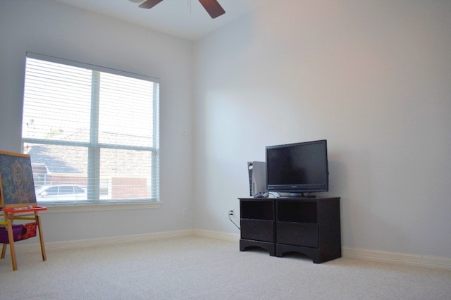 interior space featuring light carpet and ceiling fan