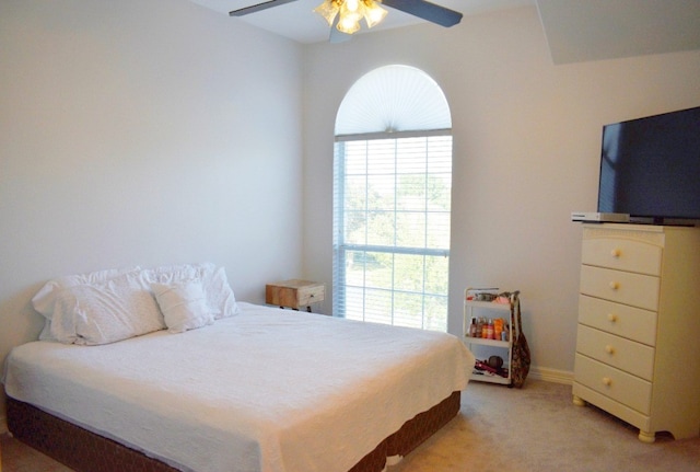 bedroom with ceiling fan and light colored carpet