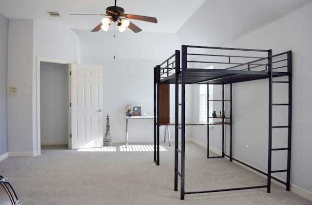 bedroom with light carpet, ceiling fan, and vaulted ceiling