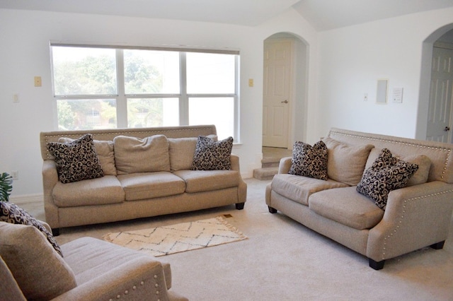 living room featuring carpet floors and lofted ceiling