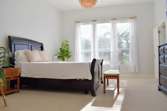 carpeted bedroom with lofted ceiling