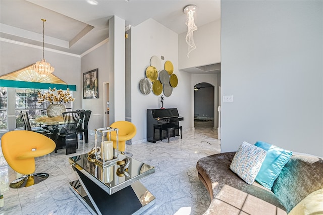 living room with a notable chandelier and a towering ceiling