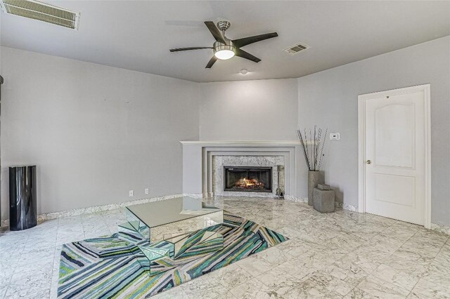 living room featuring a fireplace and ceiling fan