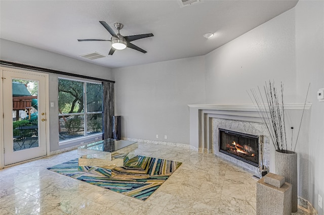 living room with a fireplace and ceiling fan