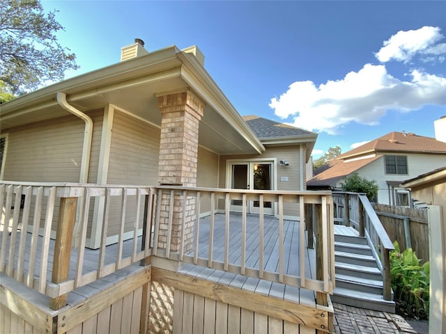 rear view of property featuring a wooden deck