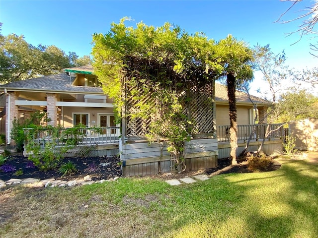 back of house with a yard and a deck