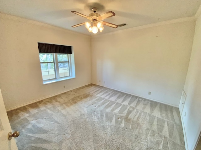 carpeted empty room featuring ornamental molding and ceiling fan