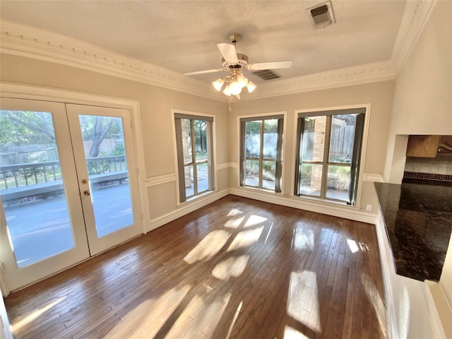 doorway to outside with wood-type flooring, ornamental molding, and a wealth of natural light