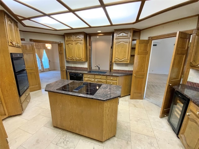 kitchen with decorative backsplash, a kitchen island, black appliances, dark stone counters, and sink