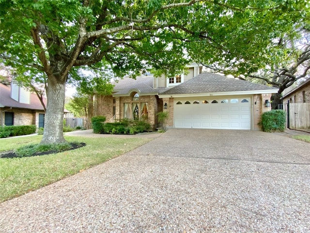 view of front of property featuring a front yard and a garage