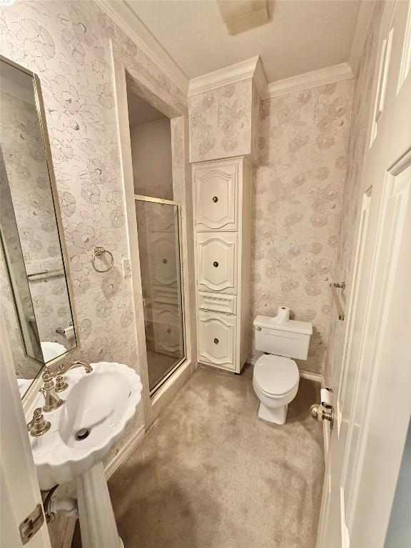 7011 Quill Leaf Cv, Austin, TX 78750 - full bathroom with crown molding, a shower stall, and wallpapered walls