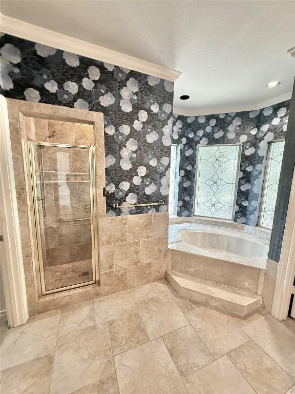 7011 Quill Leaf Cv, Austin, TX 78750 - full bathroom with crown molding, a garden tub, a shower stall, and wallpapered walls