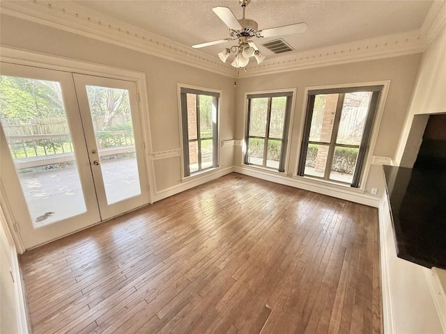 7011 Quill Leaf Cv, Austin, TX 78750 - unfurnished living room featuring crown molding, french doors, wood-type flooring, a ceiling fan, and a textured ceiling